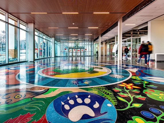 College hallway displaying Indigenous inspired artwork on floor